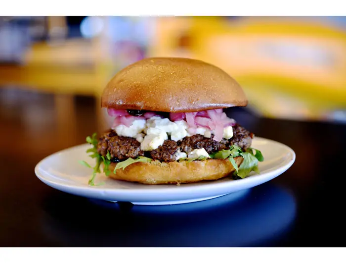 The Mascot at Bernie's Burger Bus. Bison burger topped with goat cheese, baby arugula, pickled red onions and a chipotle blackberry BBQ sauce. Photo courtesy Kimberly Park. 