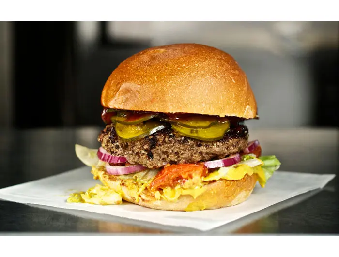 The Principal at Bernie's Burger Bus. Classic burger with choice of cheese, all homemade mayonnaise, mustard, ketchup, thinly sliced onions, pickles, shredded lettuce and slow-roasted garlic tomatoes. Photo courtesy Jody Horton. 