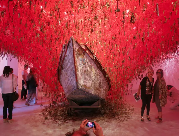 Japanese Pavilion, Giardini: Chiharu Shiota's “The Key in the Hand.”
The artist creates this large-scale installation using several thousand strings of red yarn tied to keys, symbolizing the safeguard of our memories being stored behind the protection of the key to our true feelings. The two boats beneath the keys are meant to capture the rain of memories. One of my favorites.

