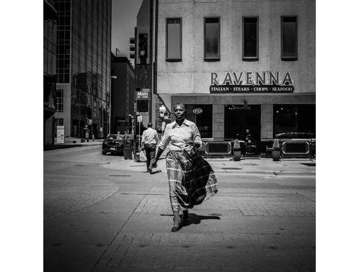 "Woman at Crosswalk," 2014, possesses the beauty of a classic gelatin silver print. It's mounted on the facade of the historic 601 Elm Street building through May 31.