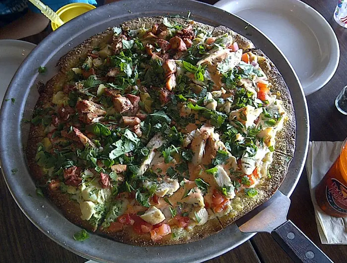 Gateway of India pizza at Bombay Pizza Co. Tandori chicken, fresh crabmeat, artichoke hearts, provolone and mozzarella on cilantro-mint chutney.  