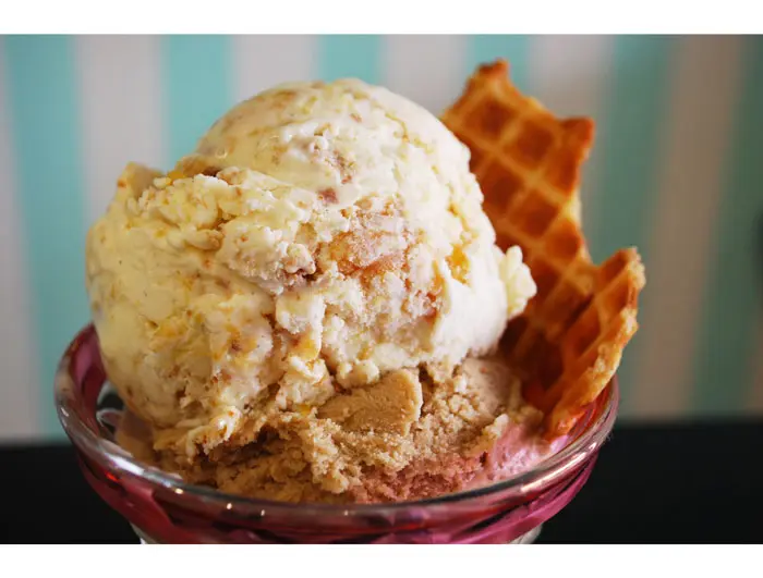 Peaches & Buttermilk ice cream (top) Amaya Coffee & Cream ice cream (bottom), with a brown butter brown sugar waffle cone shard at Fat Cat Creamery
