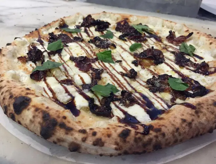 A pizza of the day at Pizaro's. Garlic, olive oil, crispy prosciutto and speck caramelized onions finished with a balsamic glaze. Photo courtesy Pizaro's Facebook Page. 