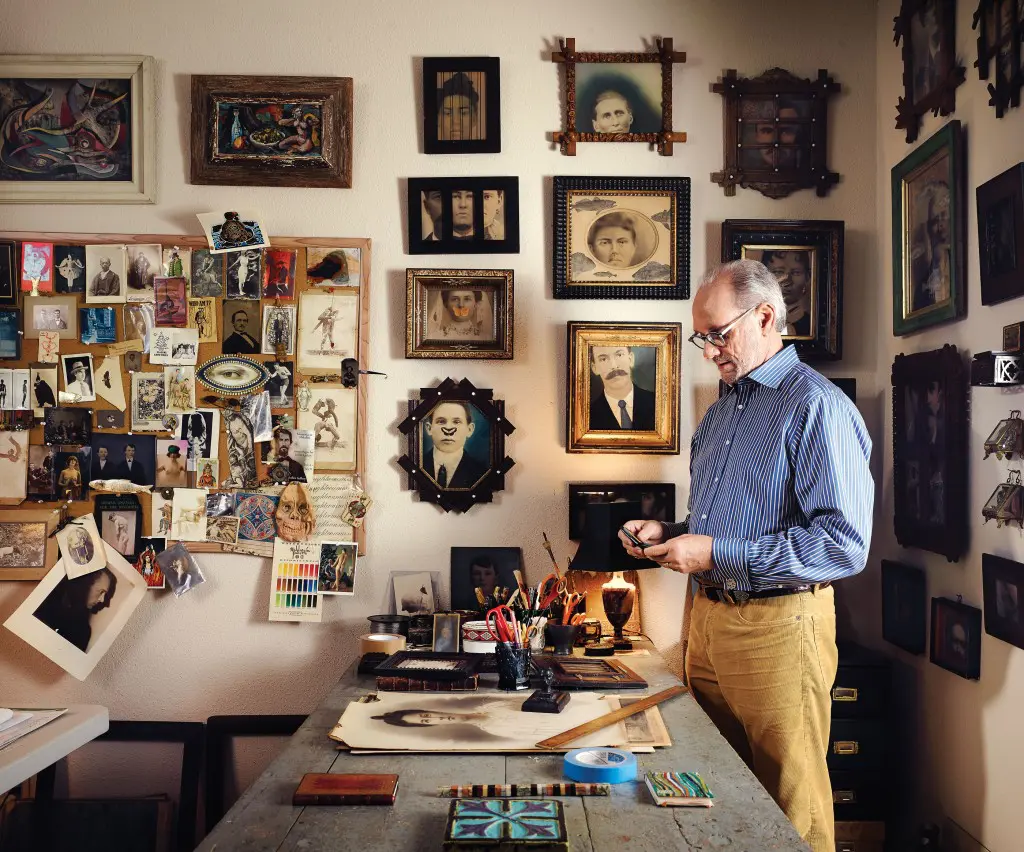 Lackey in his studio, with his work on the wall at center. Above his inspiration board are two vintage paintings,
one by Texas artist Robert Preusser.