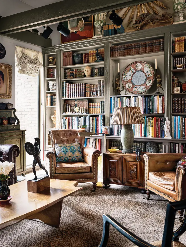 In the library, an antique Imari charger and Roseville Pottery lamp with mica shade sit atop an Anglo-Indian cabinet flanked by antique leather club chairs. At left, an antique Wilhelm Wandschneider bronze warrior is on a 1950s coffee table by George Nakashima, acquired from Sotheby’s auction of the Andy Warhol estate.