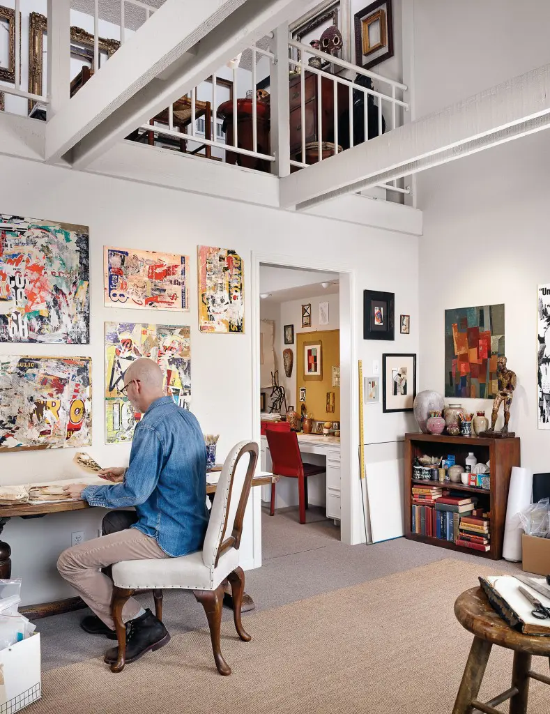 Russell Prince in his studio, surrounded by his own works.