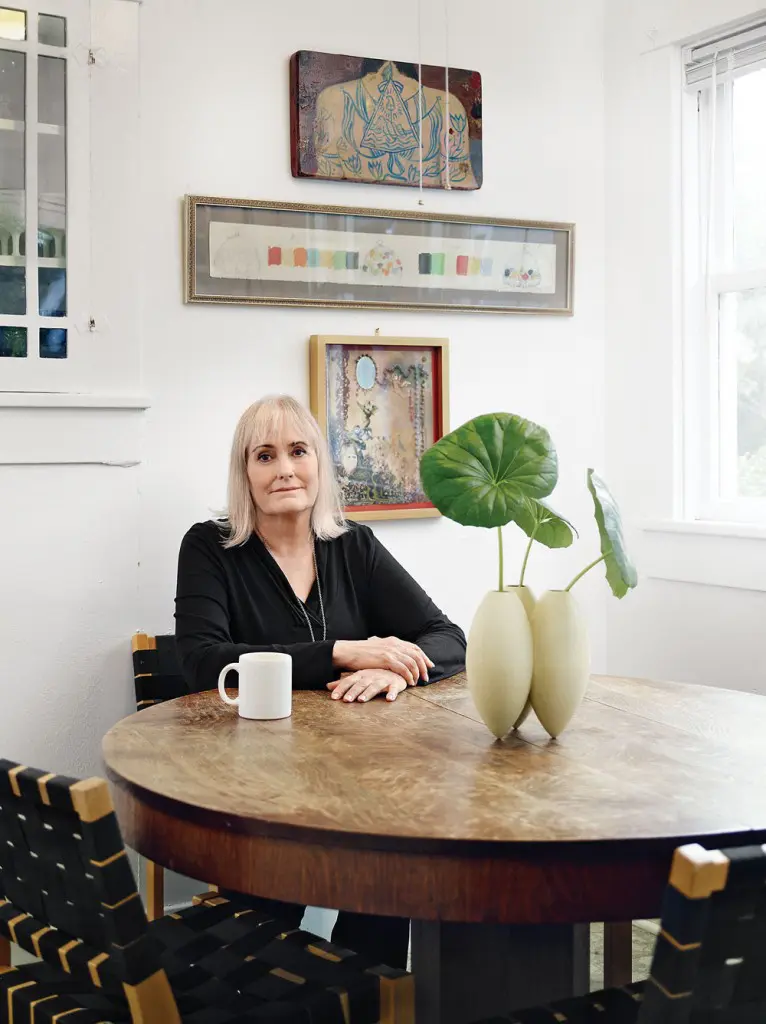 Judy Russell relaxes in the
breakfast room at a sturdy antique oak pedestal table, from her family’s home in Bellaire.