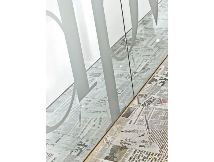 Newspaper tile in the reception area by Peronda from La Nova Tile.