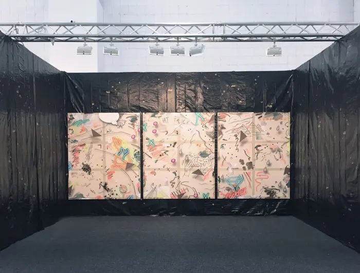Dallas native-turned-New Yorker Josh Reames at Johannes Vogt, NADA New York juxtaposed paintings with a tarp and bullet hole decals. 