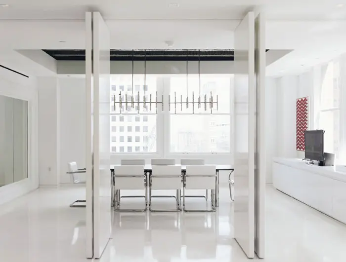 In the conference room, Jonathan Adler Meurice chandelier and vintage Knoll table and Brno chairs.