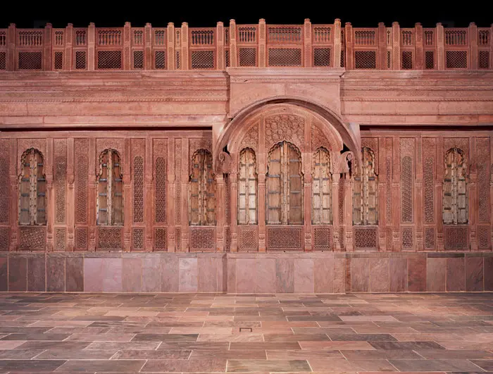 Flanking the back wall of the Crow's gallery used as a meditation space: Facade of a residence, North India, Rajasthan, Mughal period, 18th-century, formed from red sandstone carved in jali and half-jali techniques.