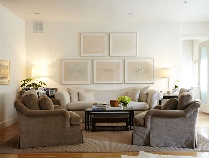 In the main living area is a collection of artworks belonging to John Bitzer by Paris-born, Taos-based cubist artist Andrew Dasburg, who was a contemporary of Gertrude Stein and Georgia O’Keeffe.  At left, an early lithograph by Joan Miró that Mary Ella purchased in the 1960s in New York City. The sofa and chairs are from Baker, and the sofa is recovered in Peacock Alley linen fabric. 