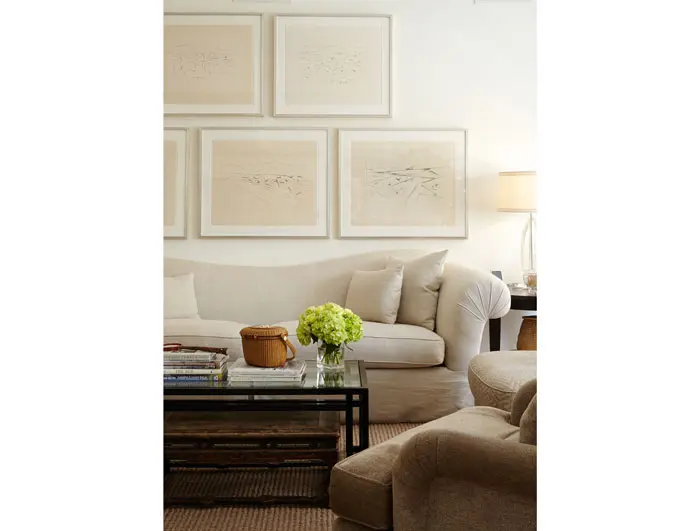 A detail of the main living area includes a collection of artworks from Santa Fe that belong to John Bitzer. A contemporary coffee table is paired with an antique Chinese table. 