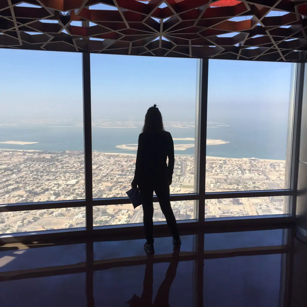 Standing atop the world's highest building, Burj Khalifa in Dubai, on the 125th floor.