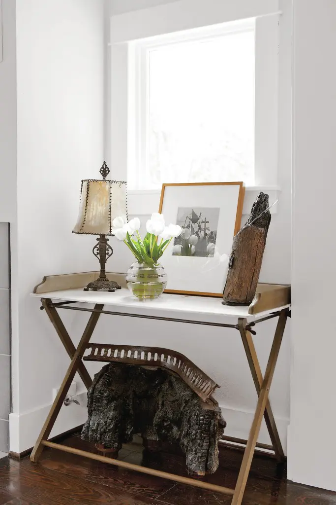 In one nook in the living room, a wood-and-marble table grounds a beautiful vignette. Vintage print by Trudi Blom, gifted to Cusack by her mom, Barbara Hill; the image records people of the vanishing Lacandon Rain Forest, Chiapas. Underneath, one of Cusack’s sculptures features charred wood from her “Campfire Stories,” exhibited at Koelsch Gallery, 2009.