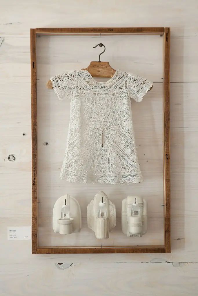 The ethereal "Three Wishes," 2013, combines an antique christening
dress with a diminutive hanger from Hôtel Lotti, Paris. It was exhibited last fall in “3” at Cusack’s long-time hometown dealer, Koelsch Gallery.