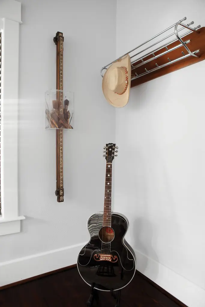 In one corner of the sitting room, an homage to Cusack’s late husband, musician Tim McGlashen — the singer’s hat and guitar. To the left, the artist’s assemblage "Paint by Numbers," 2013.