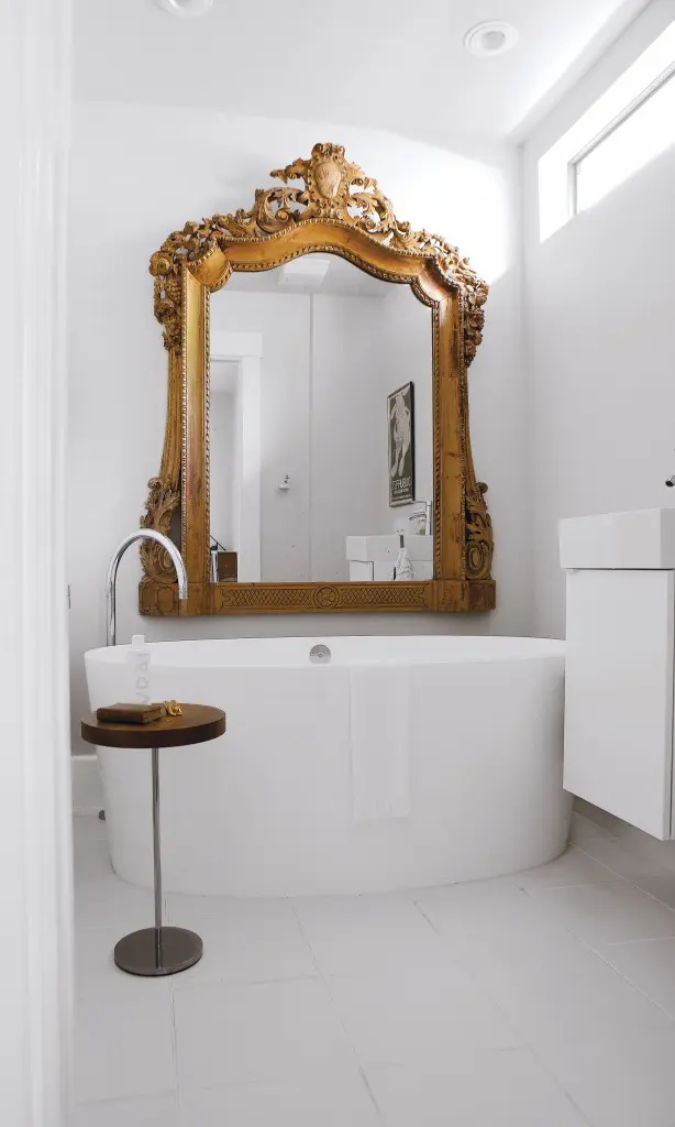 The master bath is all about sculpture, beginning with the imposing Victoria & Albert-era mirror from Kuhl-Linscomb. Tub from Westheimer Plumbing, sink and cabinet IKEA. Ligne Roset table provides the final chic motif.