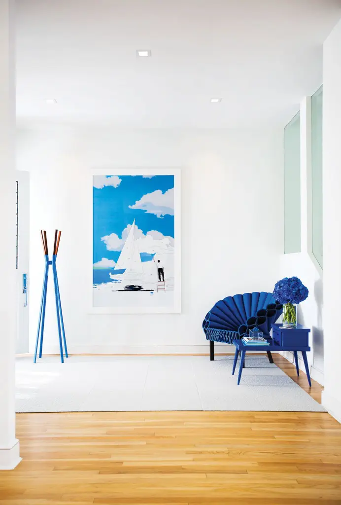 In the entry, coat rack from Design Within Reach. Paint by Numbers photograph by Fredrik Broden. Felt Peacock chair by Dror Benshetrit for Cappellini, from Scott + Cooner. Vintage table painted cobalt.