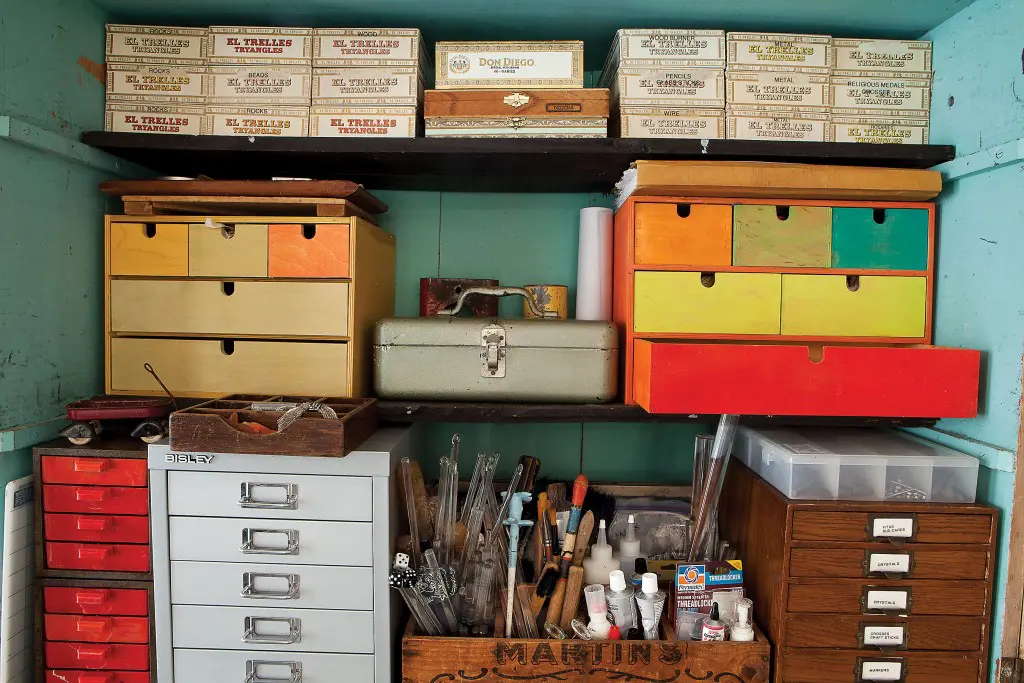 Tools, drawers and her dad’s cigar boxes line a work cabinet.