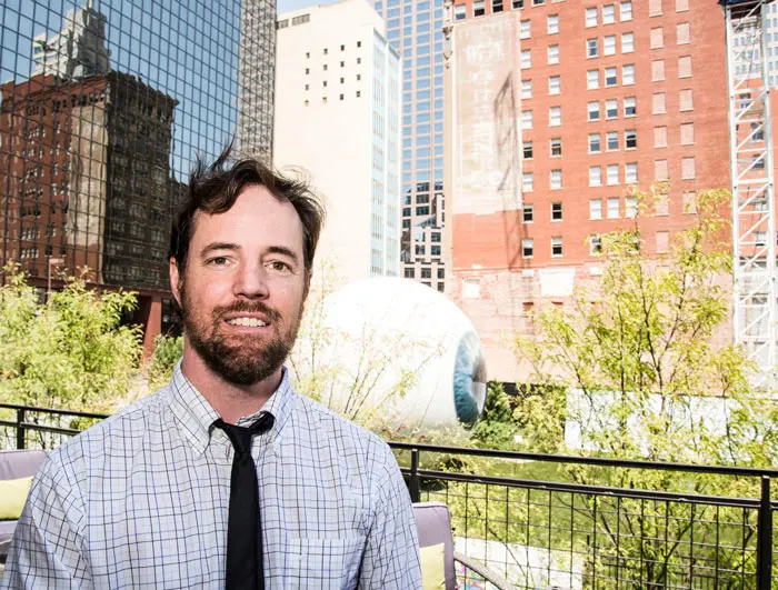 Cantrell with one of his inspirations, the construction scene surrounding Tony Tasset's iconic "Eye" sculpture across from The Joule Hotel on Main Street
