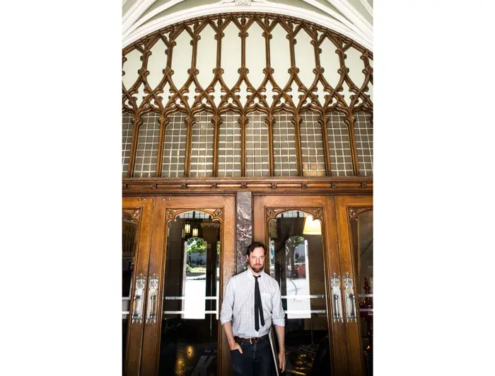 The artist exits the historic Kirby building, in the heart of downtown Dallas' Main Street District.
