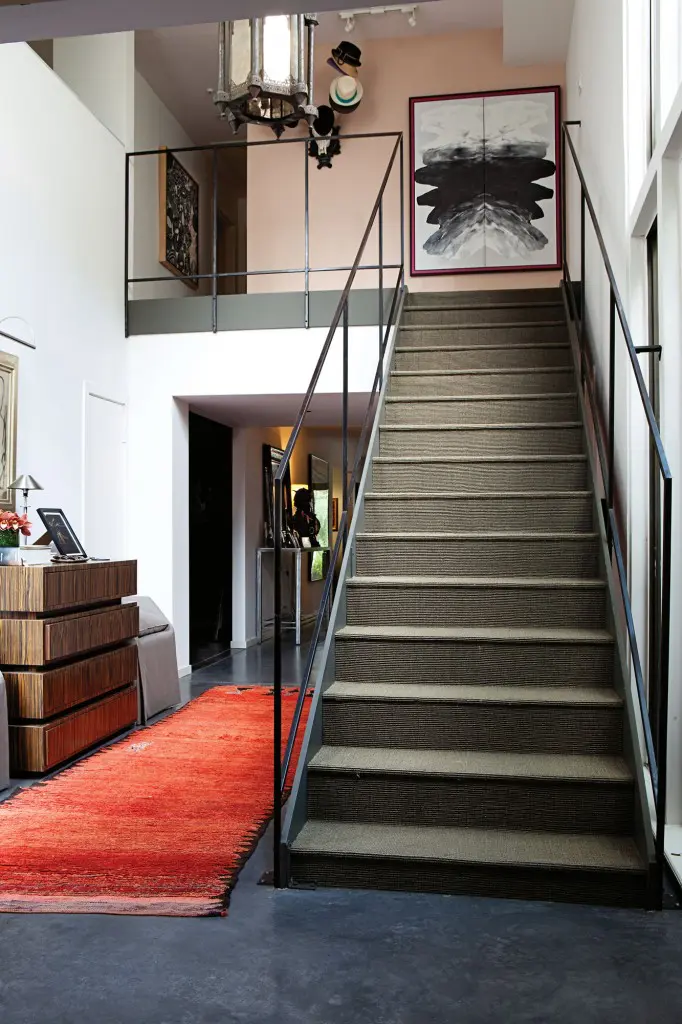 Moroccan rug from the Souk covers the entry floor. Gray sisal from Creative Flooring Resources runs up the stairs.