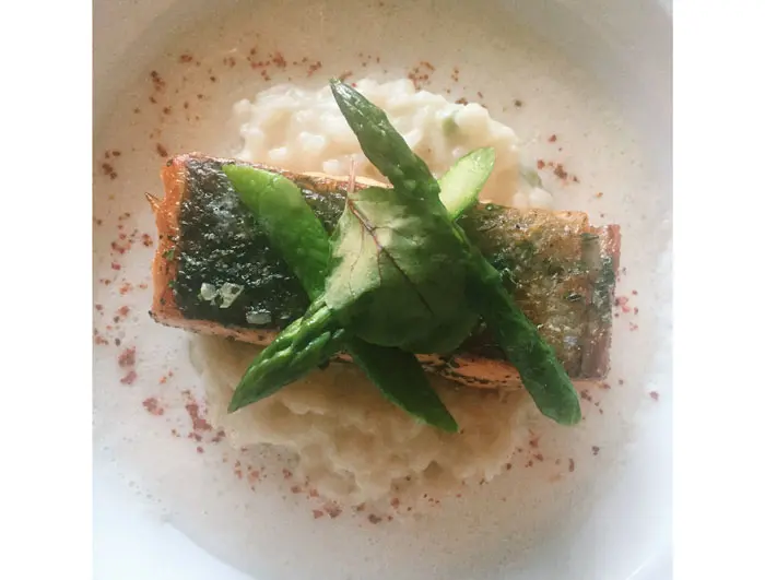 Table's roasted salmon serves as a light second-course option. It is served over asparagus risotto and a parmesan emulsion. 