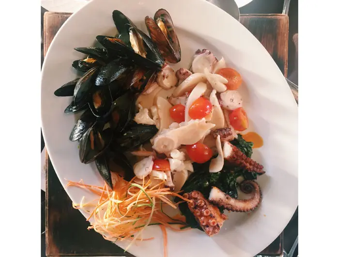Polipo ai Ferri con Salsa di Peperoni found on the Mare menu at Arcodoro. Mediterranean octopus grilled and served with braised escarole, olives, anchovies, roasted bell peppers and
oregano sauce. 