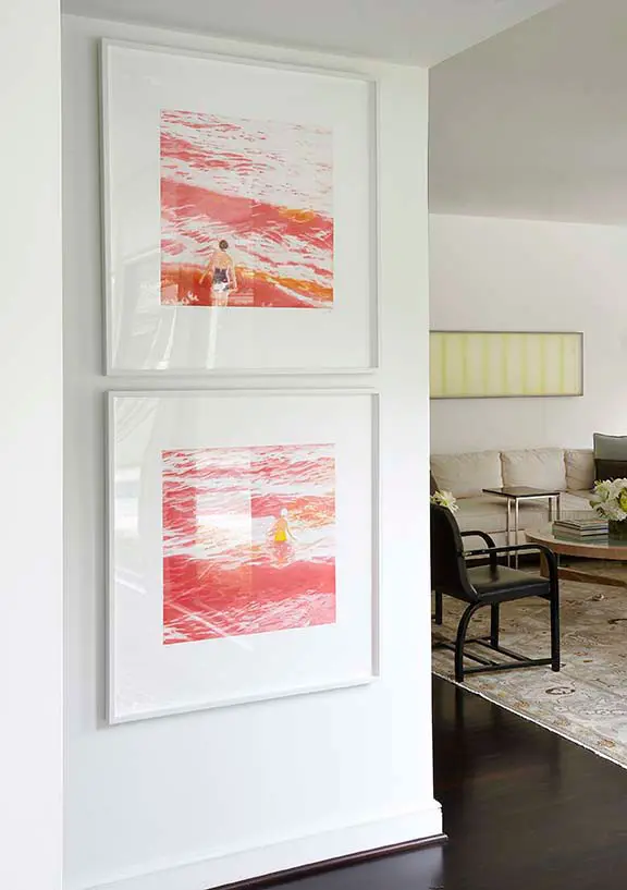 Pair of artworks on the wall by Isca Greenfield- Sanders, daughter of artist Timothy Greenfield-Sanders. In the TV room beyond, artwork above the sofa is by McKay Otto, a gift from the artist. The black chairs are by Art Deco designer Gilbert
Rohde, which Smith has
owned since age 15.