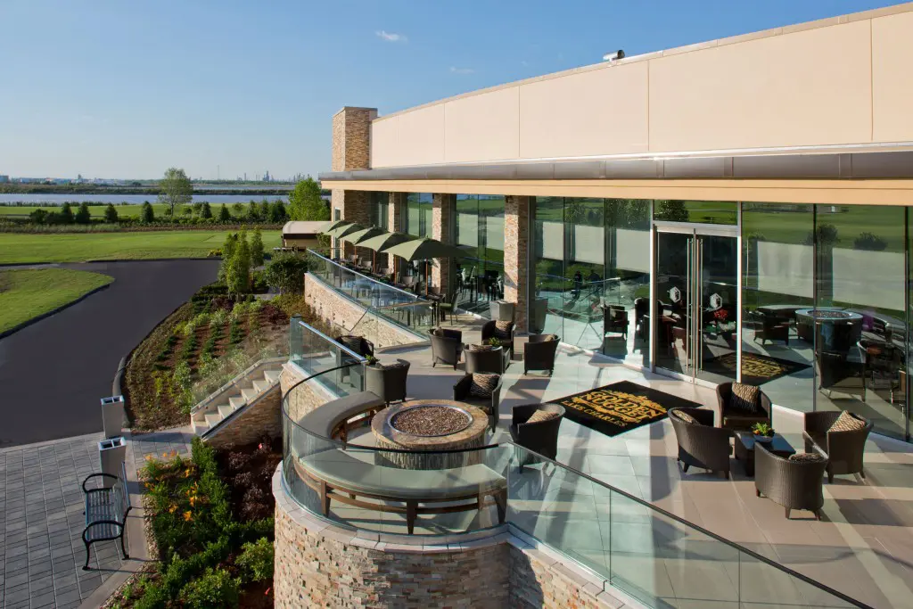An al fresco bar bordered by fire pits leads to the bayside beach front. 