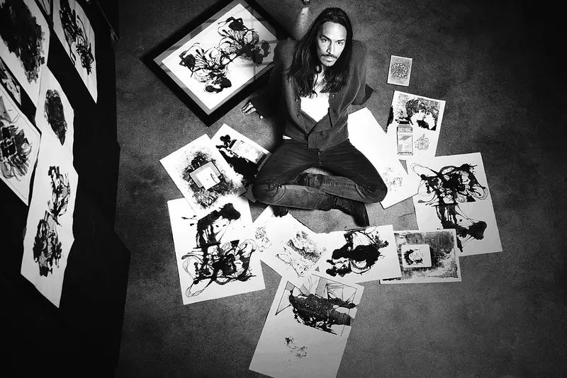 Brandon Boyd with some of his art. (Photo by Maggie Davis)