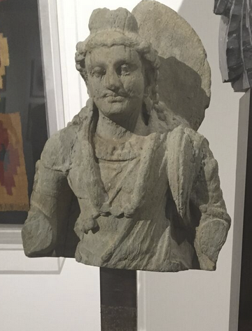 A 4th-century Buddha inspired by Apollo, in Muzeion's booth. (Photo by Nancy Gutierrez.)