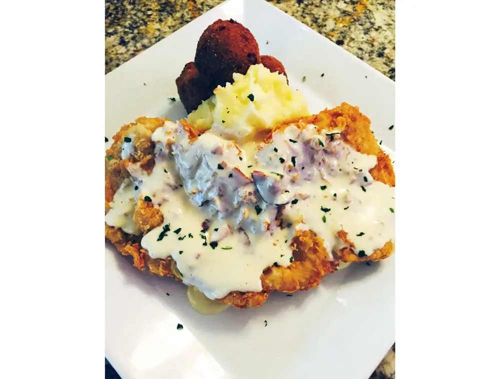 White Oak's chicken fried chicken uses free-range chicken and is served with jalapeño and pork belly gravy, corn fritters and Yukon Gold smashed potatoes. 