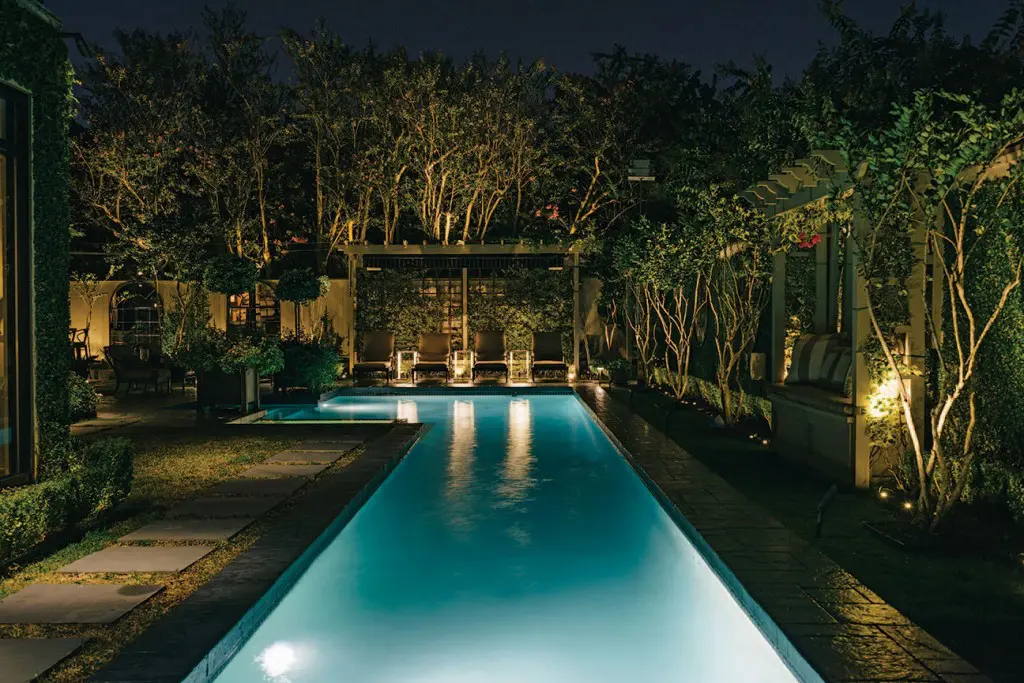 Lap pool and landscaping illuminated by hundreds of LED lights.