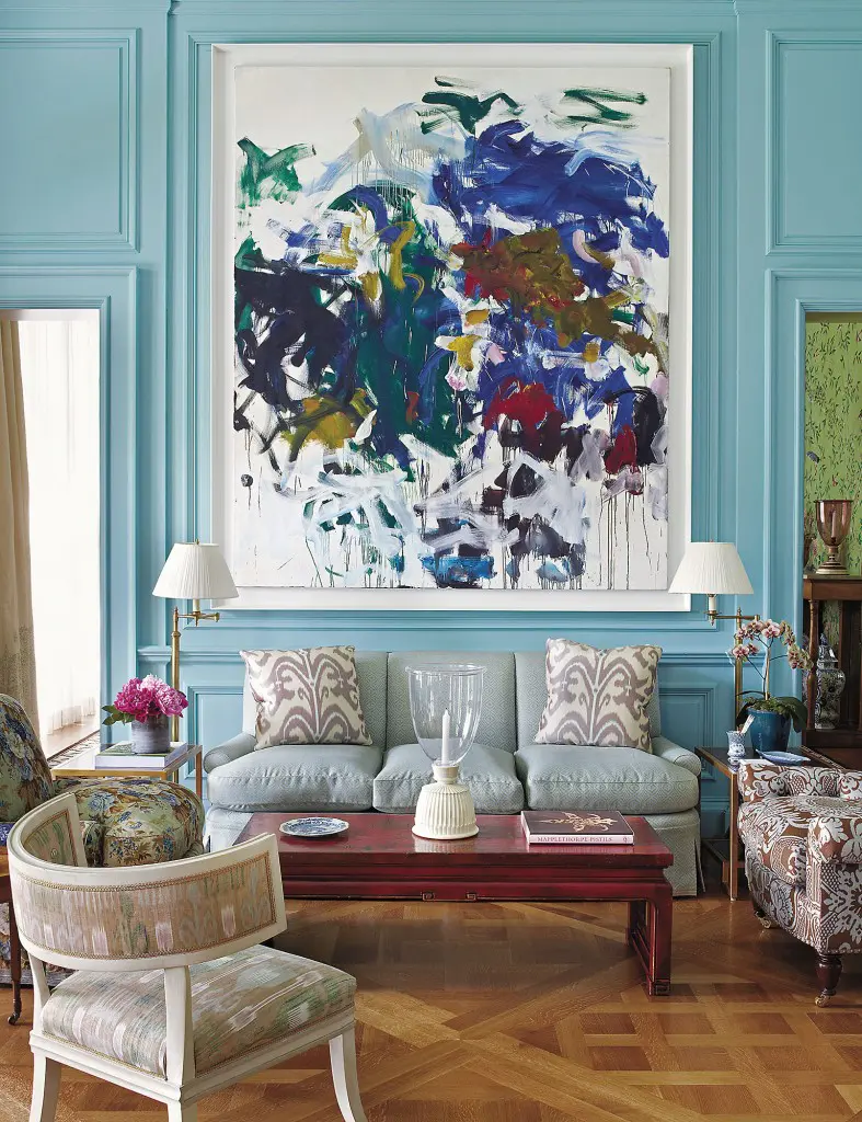 The strong color in this living room in a Long Island home is an exciting background for the Joan Mitchell painting. (Photography by Fritz von der Schulenberg)