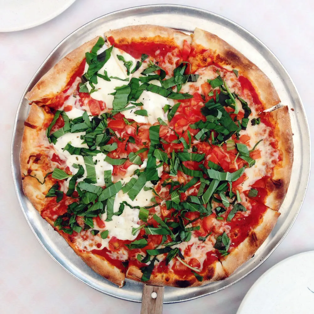 Half-margherita and half-caprese pizza at Luigi's. 