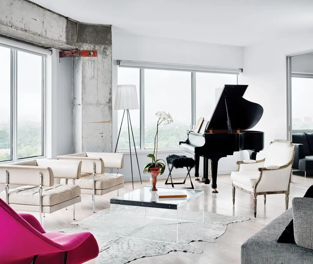 In the living area, pair of vintage Italian leather chairs and French gold-leaf bergère, all from Watkins Culver. Vintage Plexiglas and steel coffee table from Found. Philippe Starck Rosy Angelis floor lamp for Flos. Silvered cowhide rug and furry piano stool, both from Vieux.