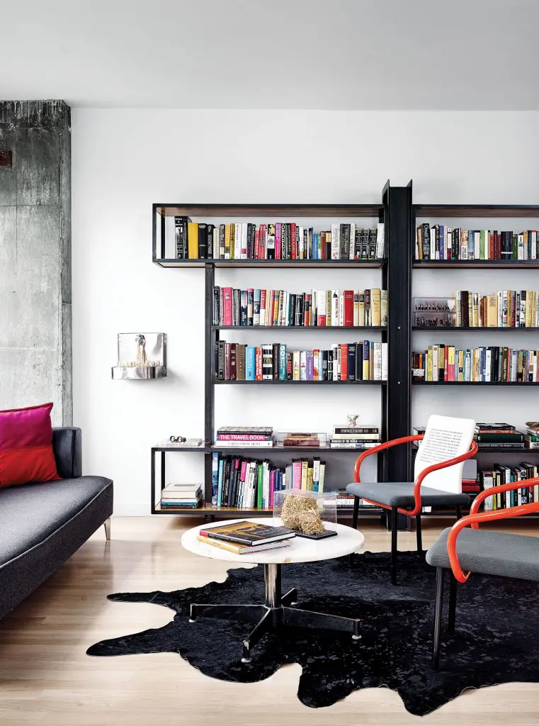 In the library, custom steel bookcase by George Sacaris. Chairs are vintage Ettore Sottsoss, repurposed by Barbara Hill for her company,
Pulpoetry. Saarinen coffee table. Claire Cusack wall sculpture, Drought.