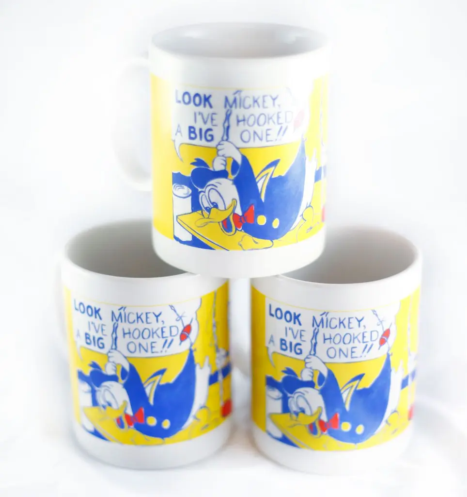 Roy Lichtenstein's Donald Duck cartoon painting rendered on coffee mugs