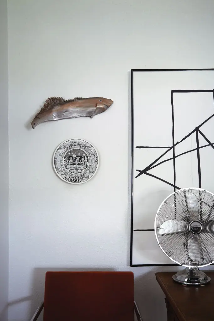 Corner vignette in living room.  The "fish" is made of the stem from a palm tree leaf by Galveston artist Ray Heard.  Koush got the the black and white painted clay plate from Fonart in Mexico City.  The vintage black and white abstract painting came from a client who was cleaning out her attic.   