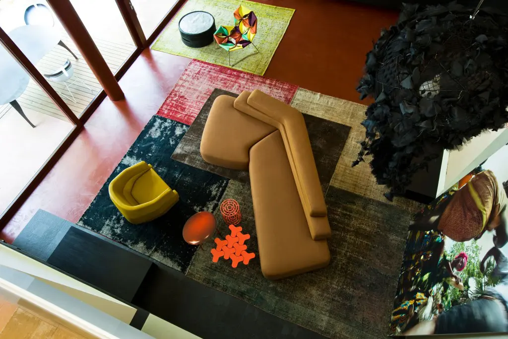 View into a main seating area on the first floor, from above. Many of the upholstered pieces were designed by Urquiola.