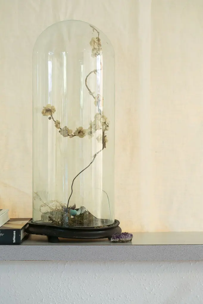 Victorian cloche from
August Antiques holds
a wire branch with
millinery flowers.