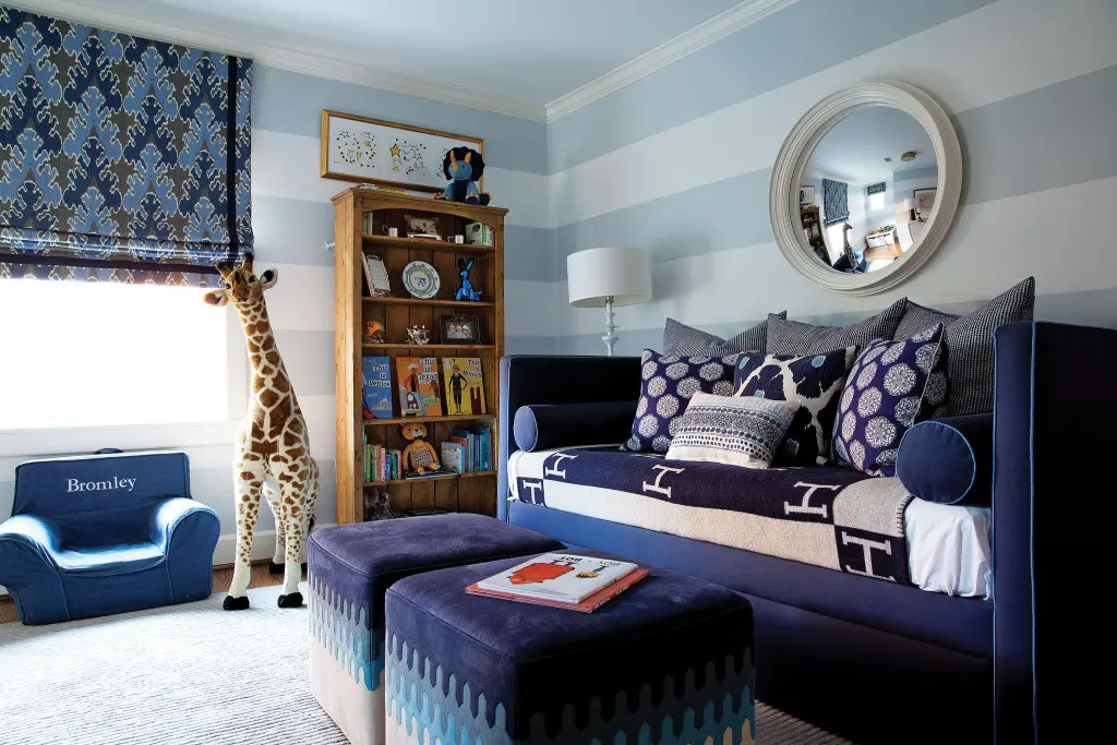 Looke made the most out of an awkward layout by embracing pattern in blue and white in her son’s room. Custom daybed is by The Joseph Company, upholstered in a Lee Jofa fabric with Samuel and Sons trim; John Robshaw pillows and Hermès Avalon blanket. A fluffy duvet hides out in the closet for sleeping. 