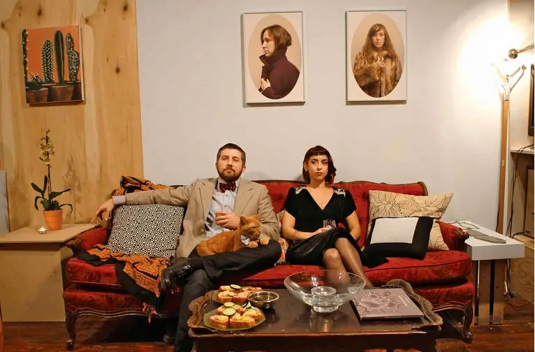 Salon style: Paul Middendorf and Olivia Abbott with Ike the feline in Middendorf's home adjoining GalleryHomeland, among Houston's most intriguing new arts venues. (Photo Marc Newsome)