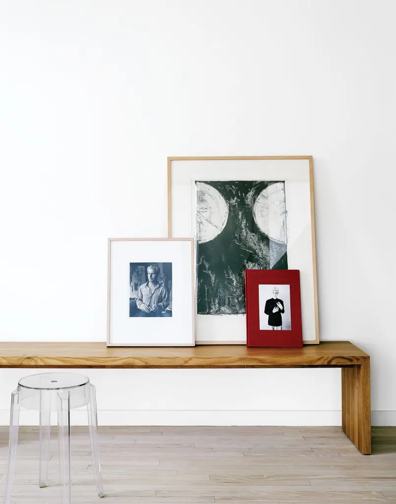 In the living room, carefully edited furniture placed in dialogue with works of art evidence Davis’ interest and curiosity about design. The natural oak Eaton bench from Ligne Roset serves as a perch for, from left, a portrait of Willem de Kooning, circa 1980s; a Jasper Johns print; and the book "Andy Warhol in China: The Photographs of
Christopher Makos." Philippe Starck Charles Ghost stool from Sunset Settings.