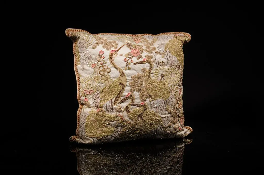 Heavily encrusted, hand-beaded with Czech glass beads stork motif tapestry; border trim detail, metallic, platinum silk welt; pale pink cashmere back with triple vintage French ribbon detail, $3,750