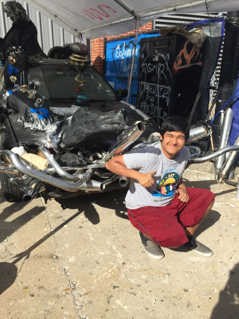 Posing with the hood of "Bohemian Rhapsody," a former 1993 Nissan Sentra.