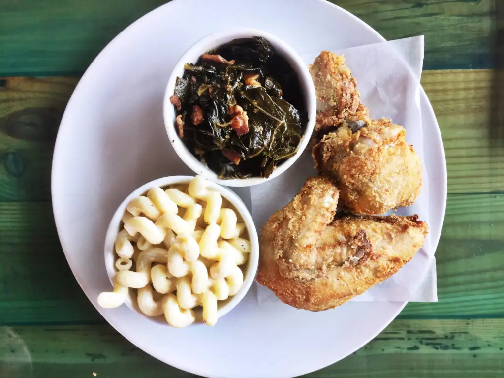 Harold's fried chicken is brined twice, with salt, sugar, and buttermilk. It's served with white cheddar macaroni and cheese and collard greens. (Photos by Jailyn Marcel) 