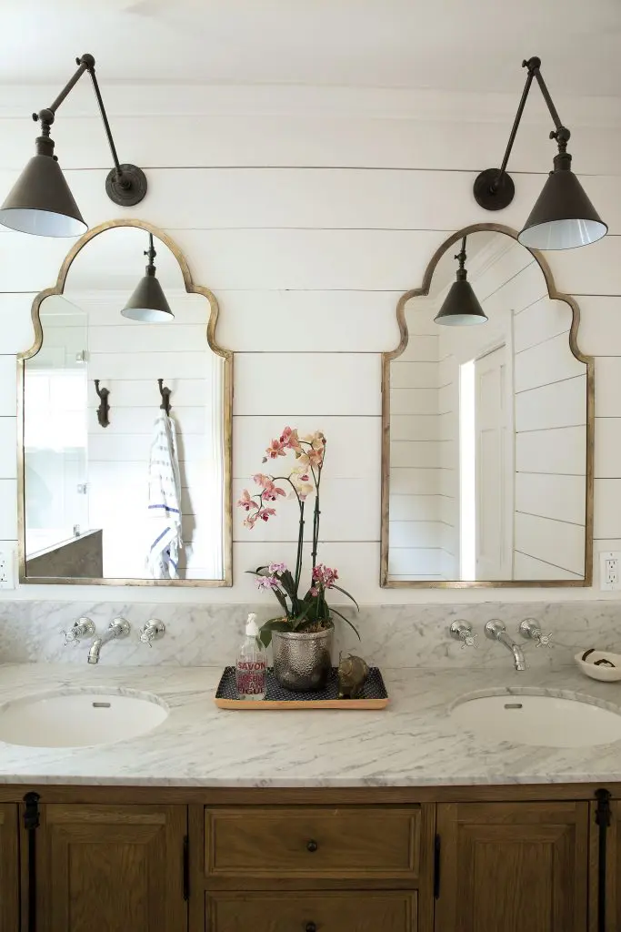 The renovated master bath with shiplap walls, Carrera marble countertop and
Hansgrohe faucets.